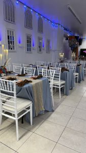 Warm glowing candles and chic floral arrangements bring this Abyss Hall table setup to life — ideal for weddings, showers, and birthdays.