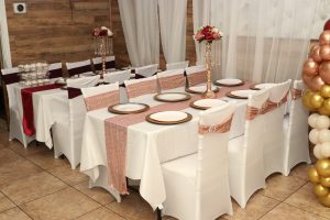 Chic rose gold and burgundy table setup at Occasions Hall. A stylish and modern design perfect for birthdays, showers, and elegant celebrations.
