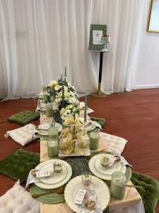 Cozy and elegant picnic-style baby shower setup at Ridgewood Hall. Soft greens, florals, and low seating create a stylish and intimate celebration space perfect for small gatherings in Queens.