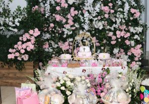 Elegant baptism cake display with pink and white floral decorations at Abyss Hall Queens NY. A perfect venue for family celebrations and milestone events.