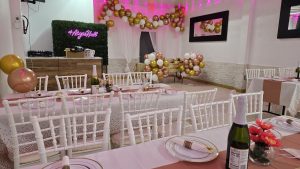 A stunning gold and white balloon garland frames the dance floor at Abyss Hall, complemented by a neon #AbyssHall sign. The perfect photo backdrop for weddings, birthdays, and baby showers.