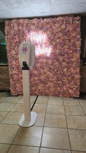 Luxurious pink and purple rose flower wall with glowing ‘Happy Birthday’ sign, perfect for Instagram-worthy party photos.