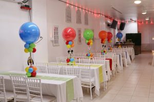 Beautiful birthday party decorations at Abyss Hall featuring vibrant balloon centerpieces and white seating. A spacious venue ideal for kids parties and family events.