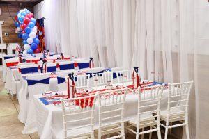 Bright and festive Puerto Rican-themed table setup at Occasions Hall in Queens, New York. Perfect for cultural celebrations, birthday parties, and community gatherings. A vibrant event space with custom decor in red, white, and blue.