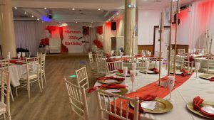Celebrate in style at Atlantis Hall! This birthday setup features classy red and gold details with modern lighting and beautiful decor — perfect for any special event.