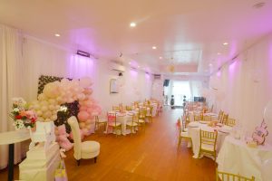 iscover a charming baby shower setup at Ridgewood Hall in Queens, NY. Featuring pink balloon arches, floral decor, and a cozy photo corner — perfect for unforgettable celebrations!