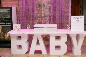 Make your guest table unforgettable with personalized touches like “Baby in Bloom” and themed backdrops. Let our team help create your dream look.