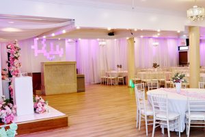 Twilight Hall event stage with floral arch and light-up wall design – perfect for weddings, performances, and special event presentations.